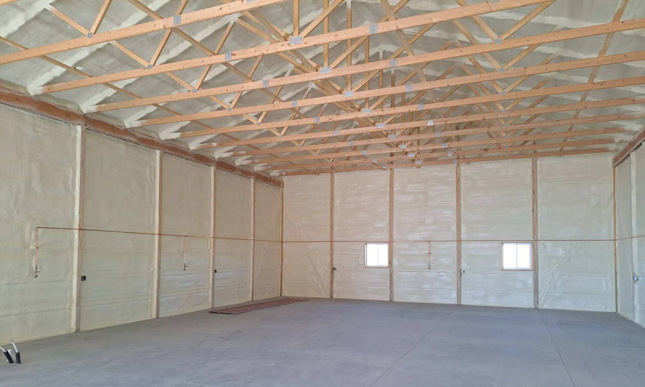 Finished spray foam on the walls and roof of a wood-framed building.